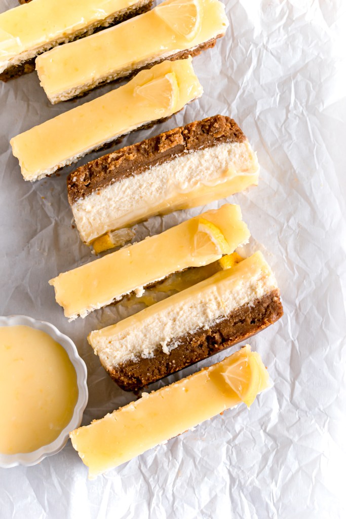 sliced lemon cheesecake bars on a parchment paper