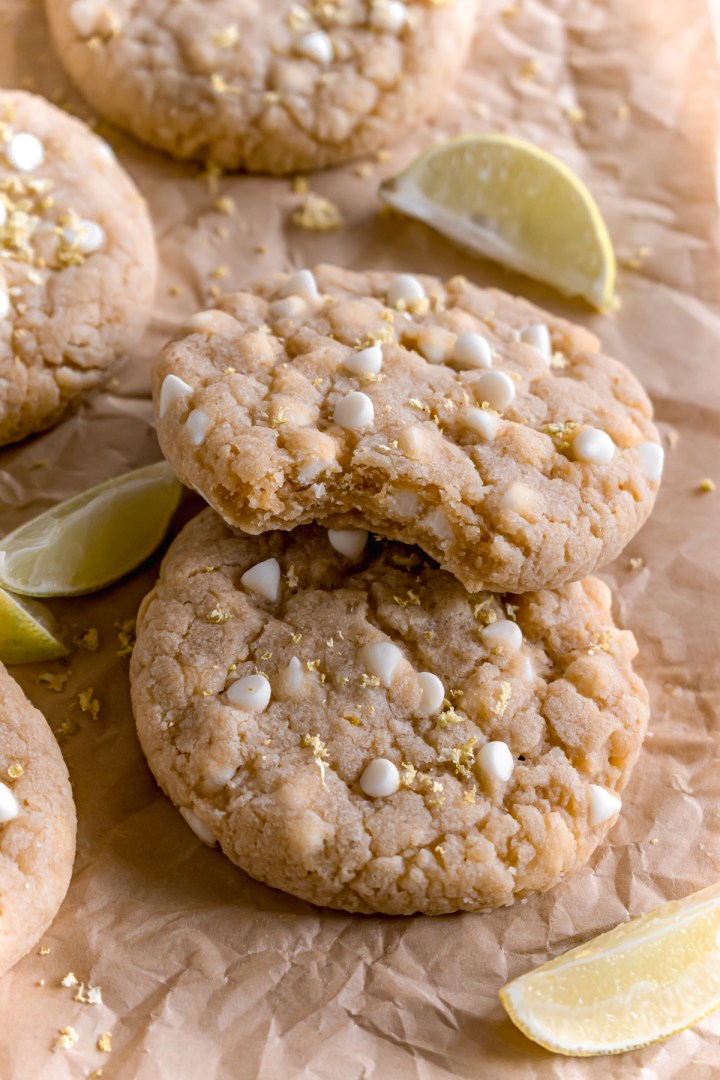 lemon and white chocolate cookies on a parchment paper with a bite taken