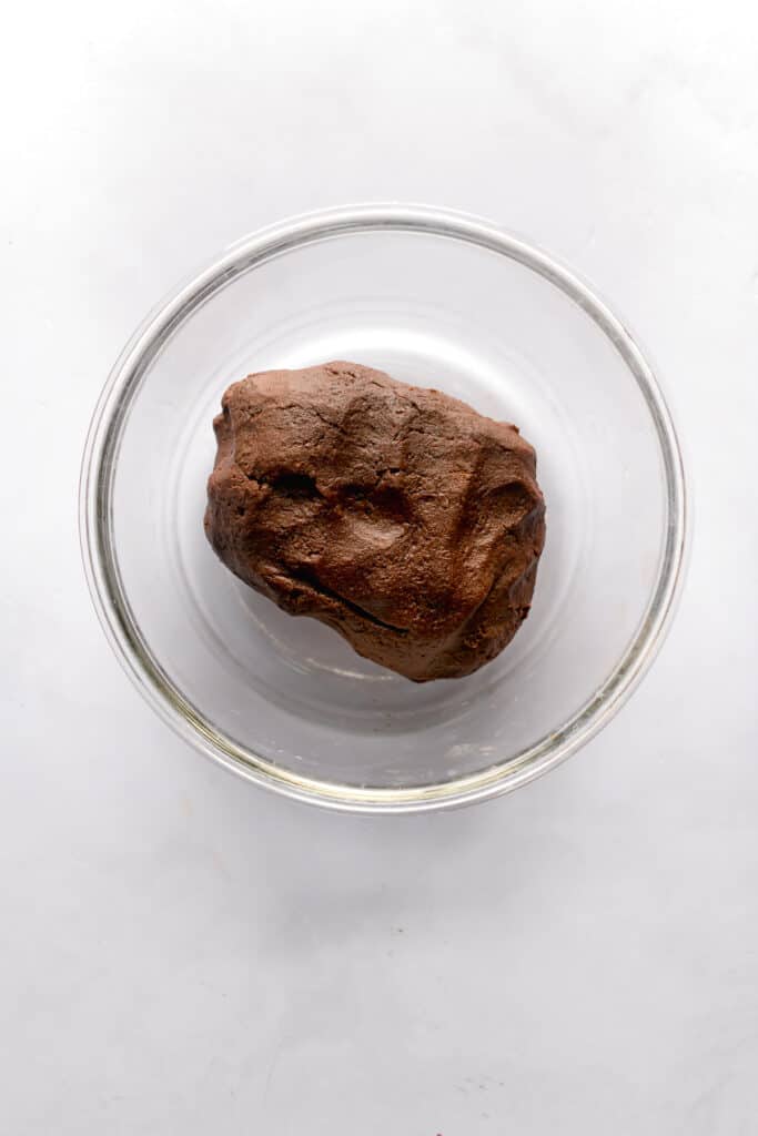 Dark chocolate cookie dough in a glass bowl