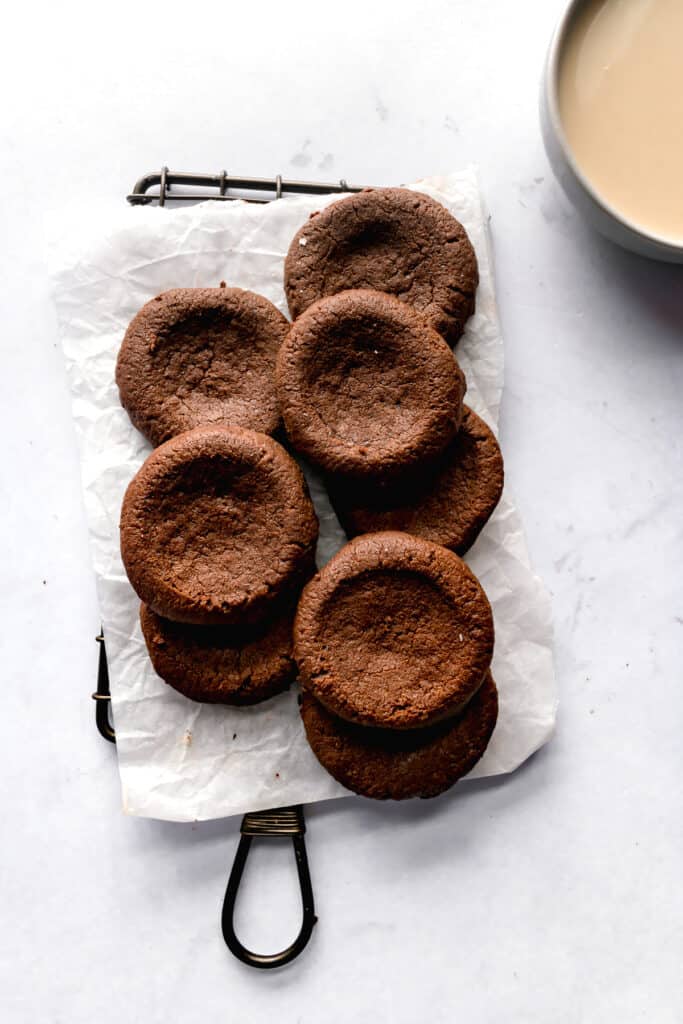 Baked dark chocolate thumbprint cookies on a wire rack