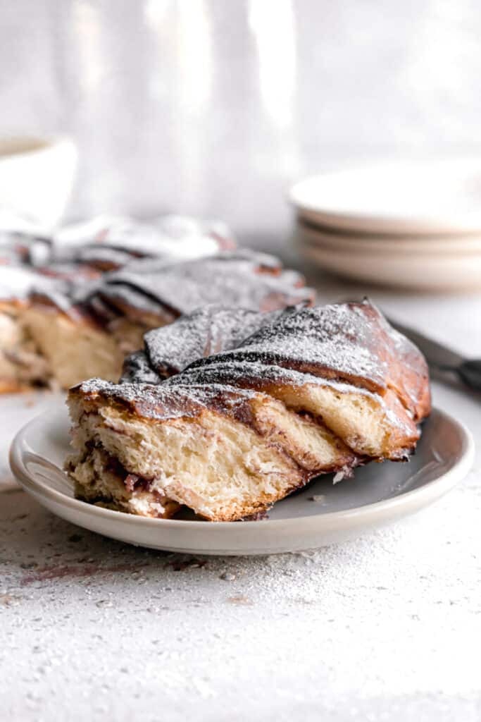 Baked Blueberry jam cream cheese star bread slice on a plate dusted with powdered sugar