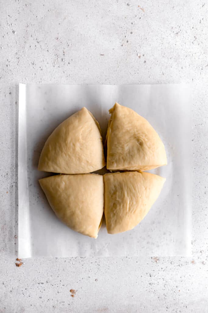 yeast dough for star bread on a parchment paper into 4 equal portions