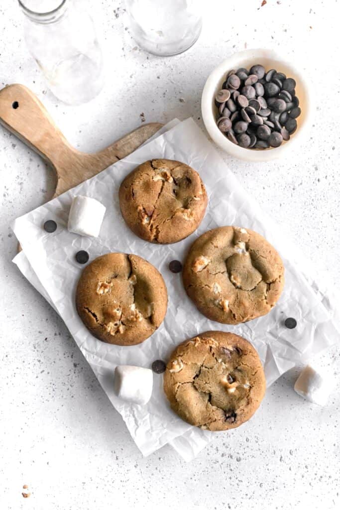 Large chocolate chip marshmallow cookies on a parchment paper