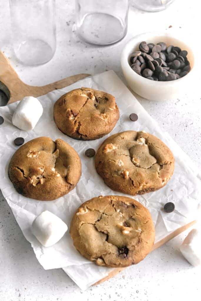 Large chocolate chip marshmallow cookies on a parchment paper