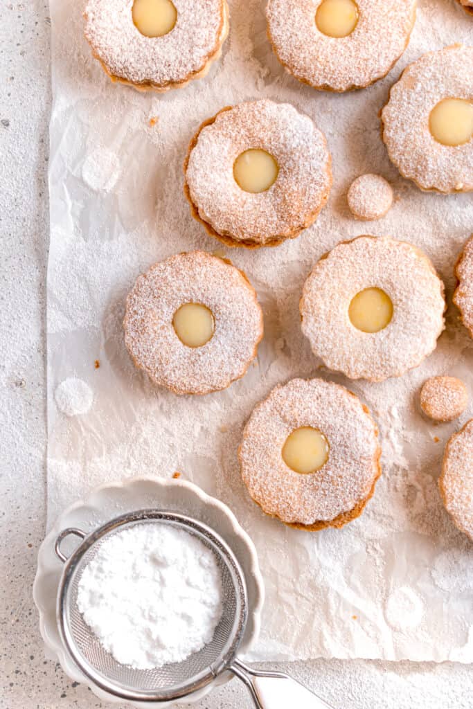 lemon curd linzer cookies on a parchment paper