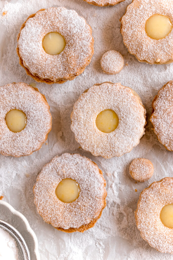 lemon curd linzer cookies on a parchment paper