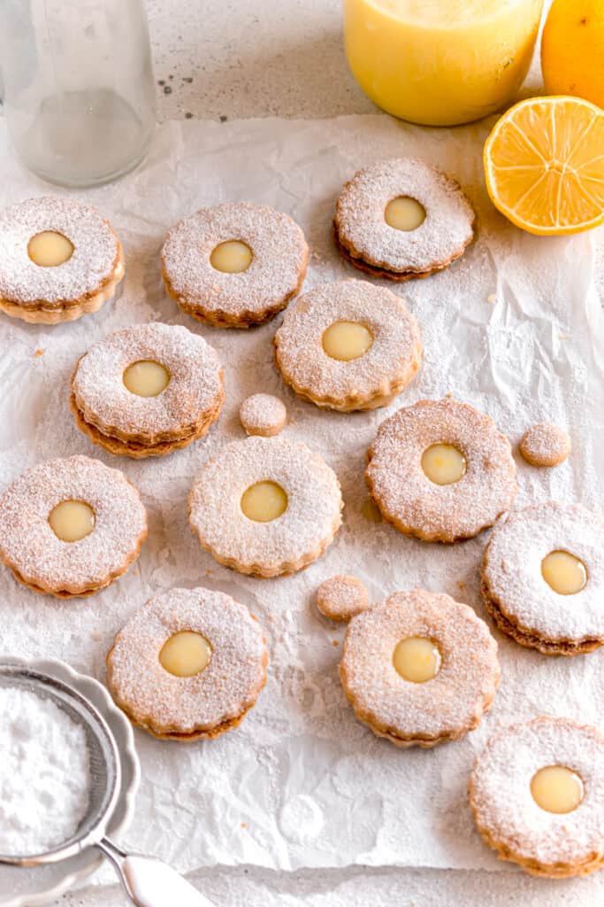 lemon curd linzer cookies on a parchment paper